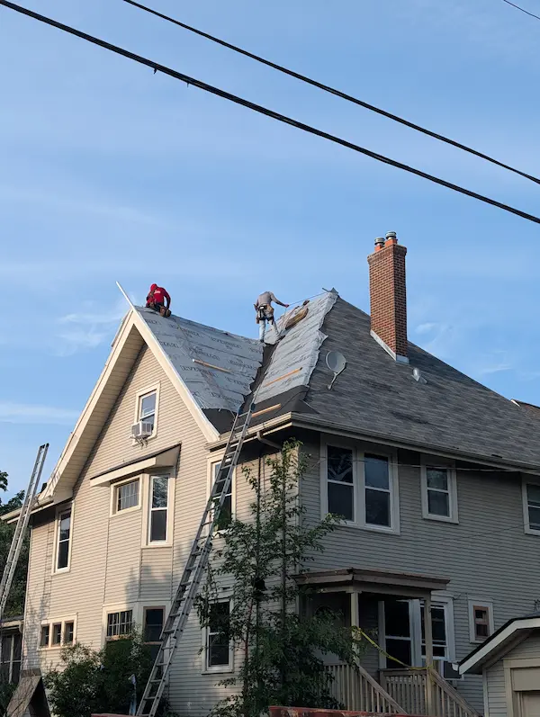 Multi-slope residential roof replacement with chimney