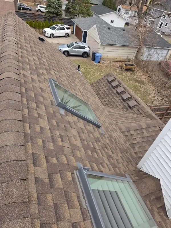 Asphalt shingle roof replacement with skylights and chimney